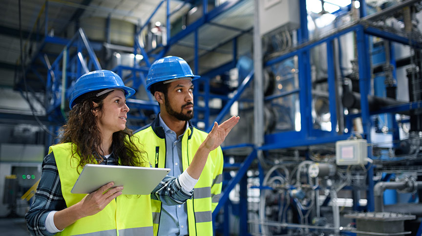 image of two people working at manufacturing jobs