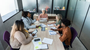 A photo of a woman and her team leading during uncertainty.