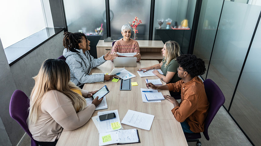 A photo of a woman and her team leading during uncertainty.