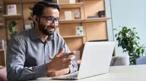 image of man on laptop talking and representing the future of coaching in a digital world